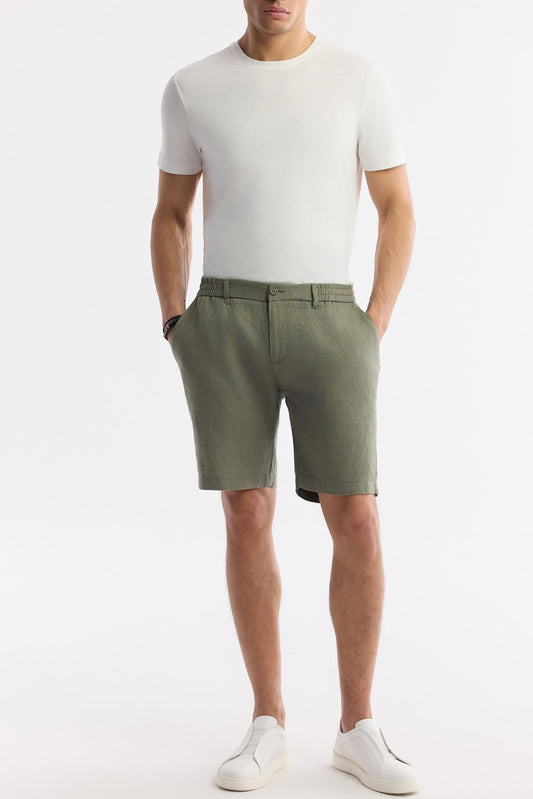 Man wearing olive green linen shorts front view