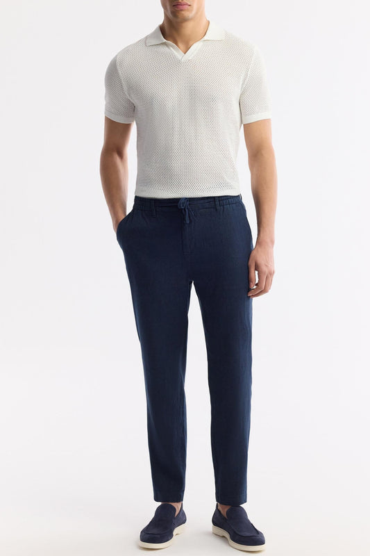 Model wearing Swiftyle Blue Linen Pants with white textured polo and navy loafers