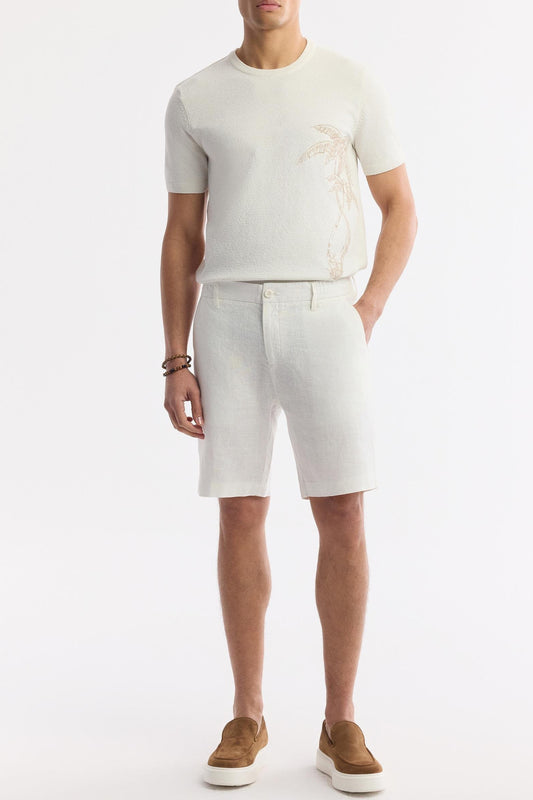 Model front-facing wearing white linen shorts, summer styling