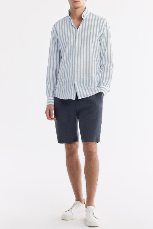 Full outfit view – model in sky blue striped cotton shirt and navy shorts – Swiftyle