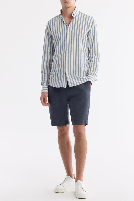 Full-body view of navy striped cotton shirt with white sneakers
