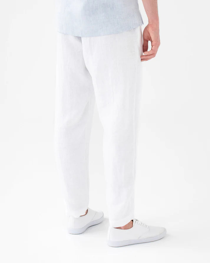Person wearing white pants and white sneakers on a white background