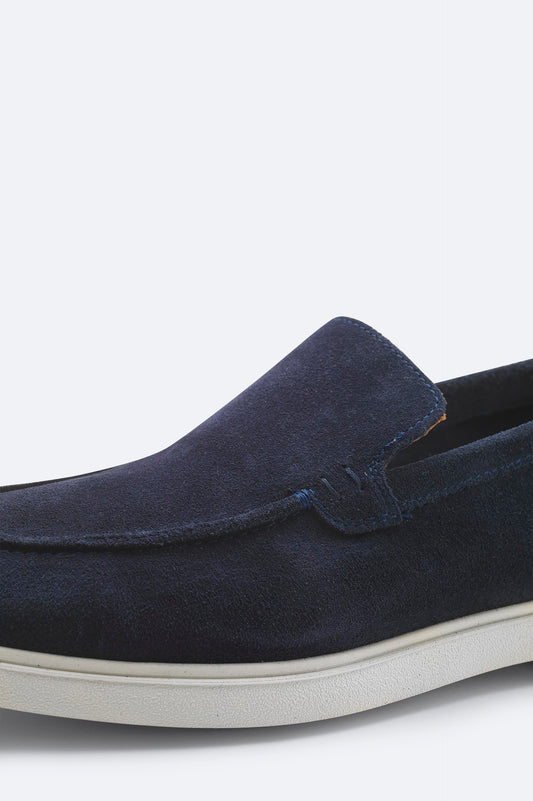 Detail close-up of navy suede loafer stitching