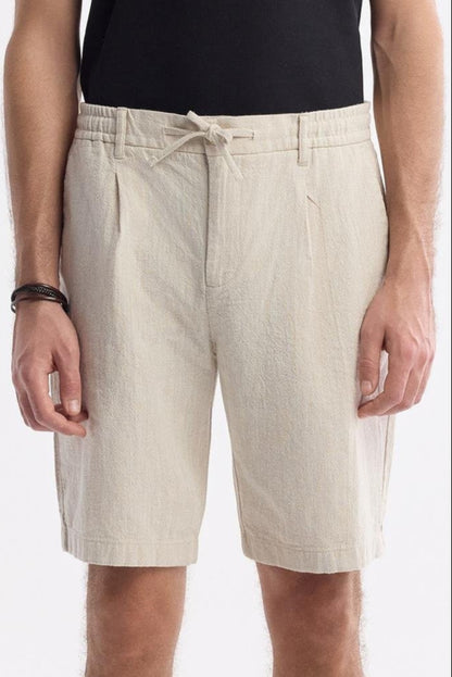 Men’s beige linen shorts with drawstring waist – front view close-up