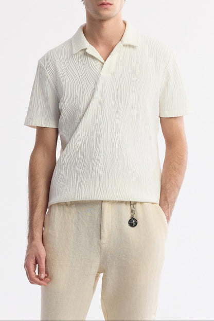 Full outfit view with polo shirt and beige linen pants