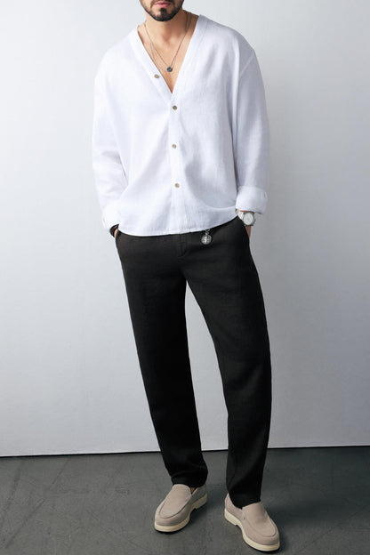 Model pairing black pants with black linen shirt, minimal styling