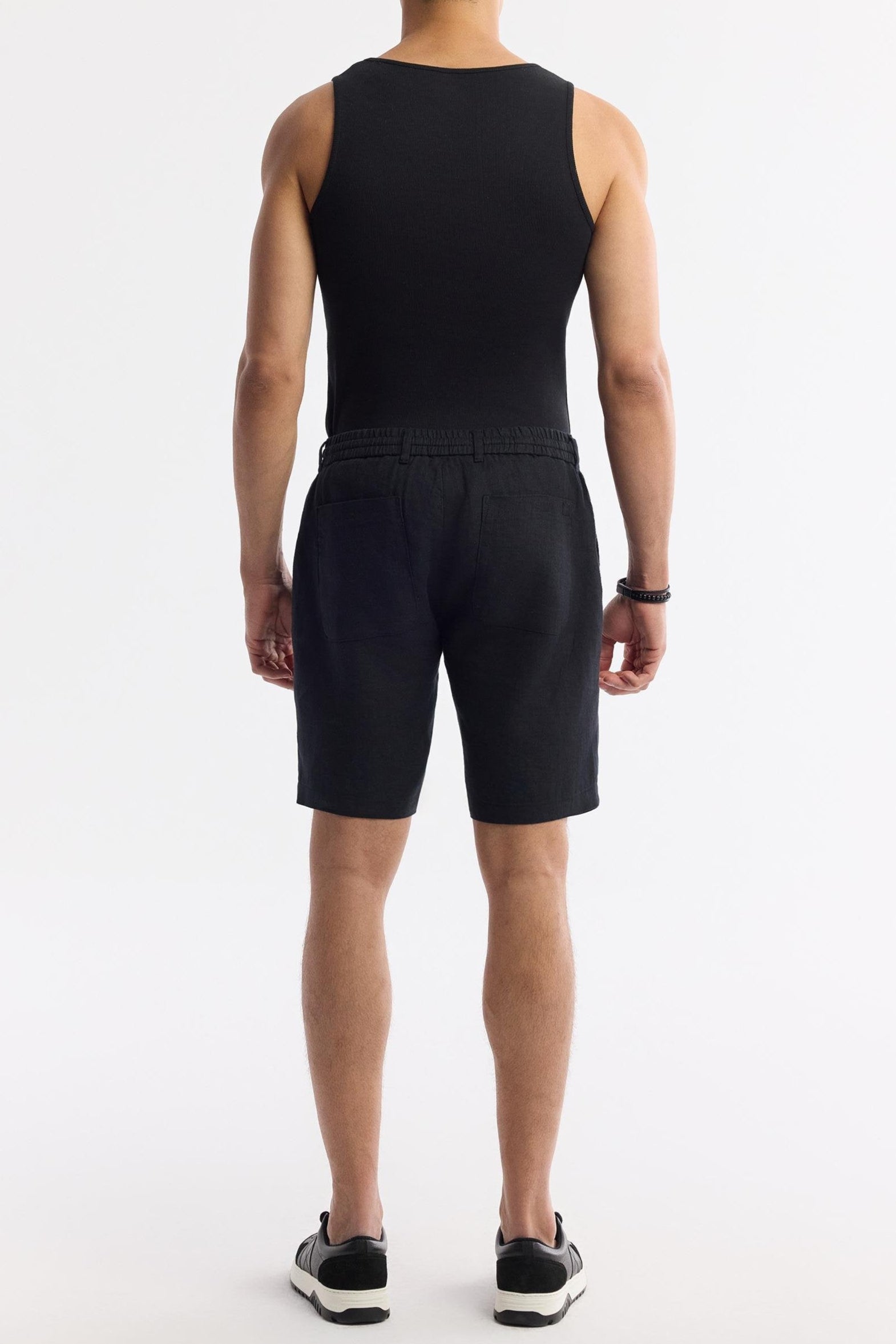 Back view of the black linen shorts with dual pockets