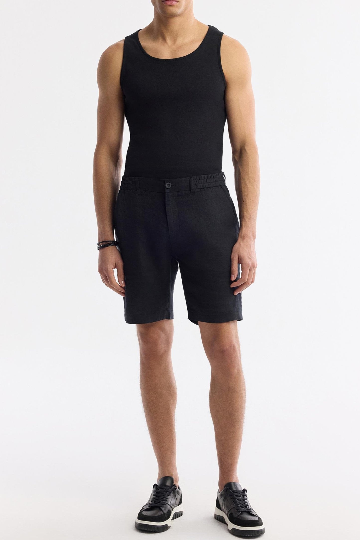 Full-body outfit featuring black linen shorts with black tank