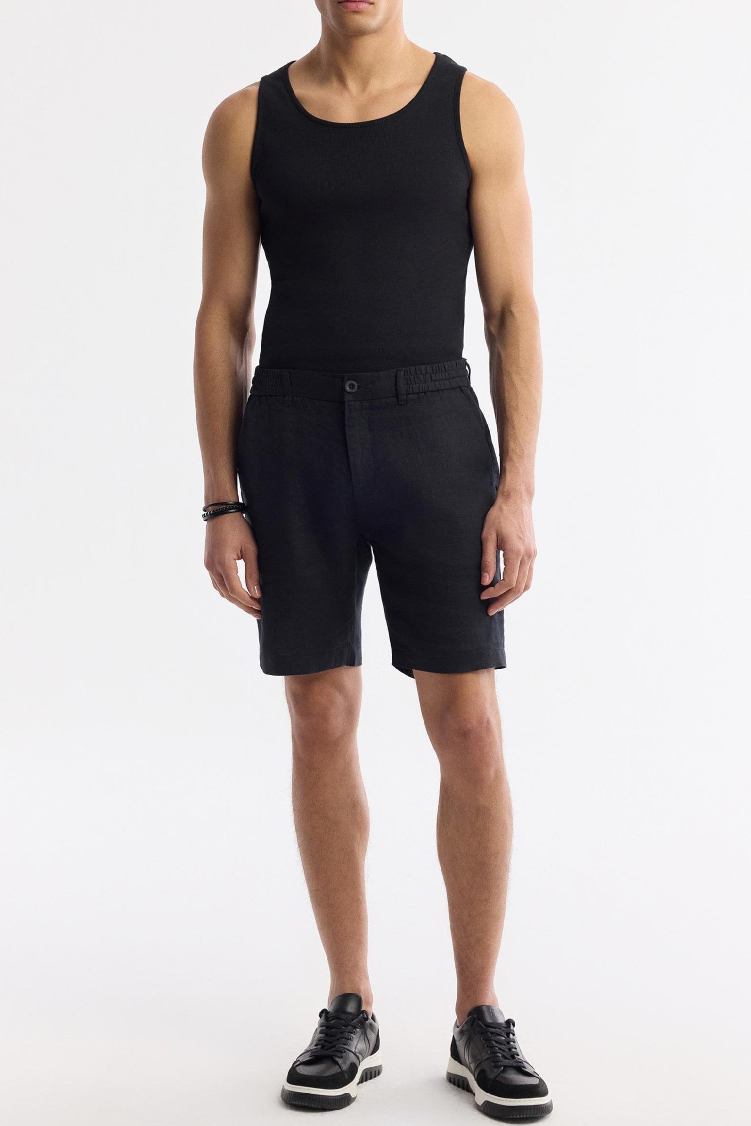 Full-body outfit featuring black linen shorts with black tank