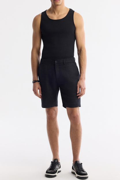 Full-body outfit featuring black linen shorts with black tank