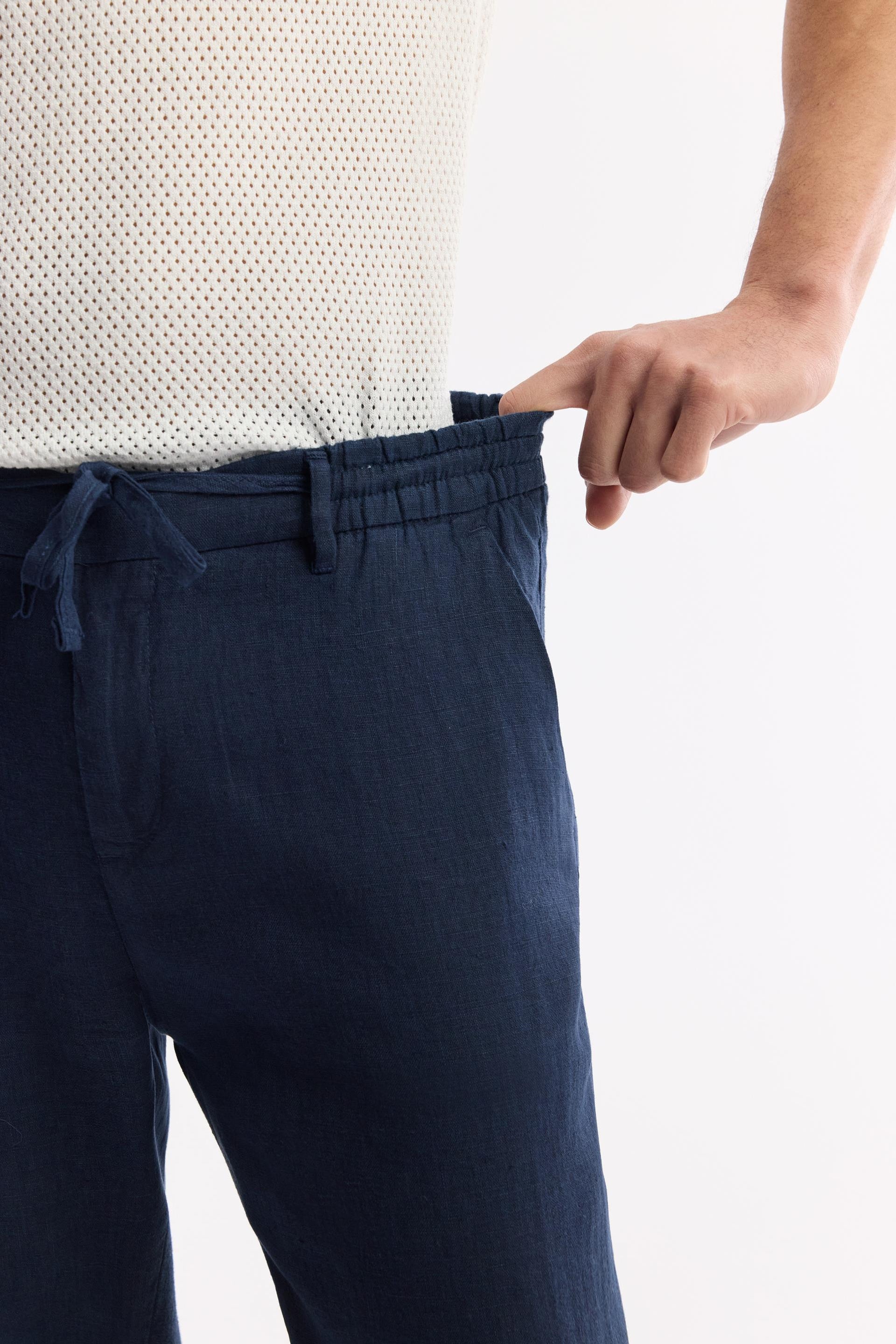 Close-up of elastic waistband and drawstring fastening on blue linen pants