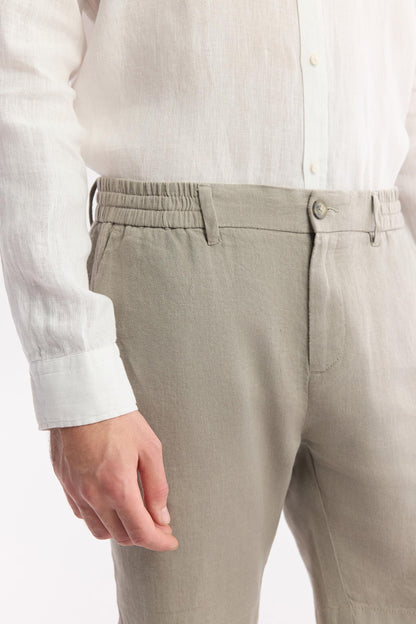 Close-up of breathable linen fabric, front closure detail, and stitched waistband
