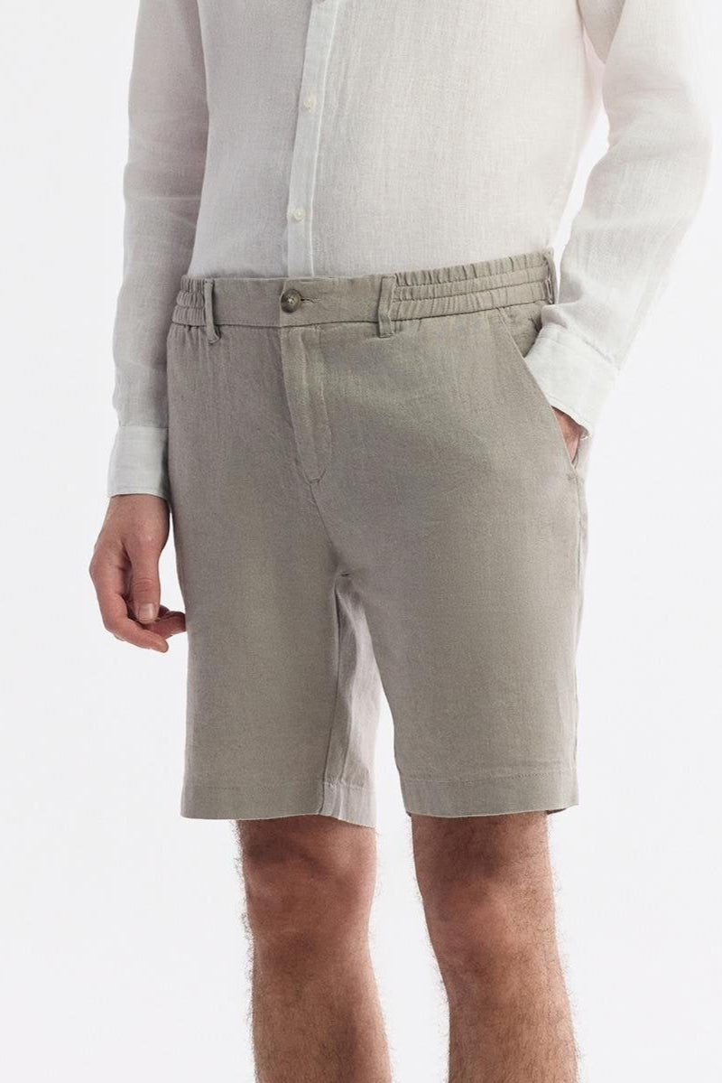 Model wearing gray linen shorts by Swiftyle – full-body front view styled with white shirt