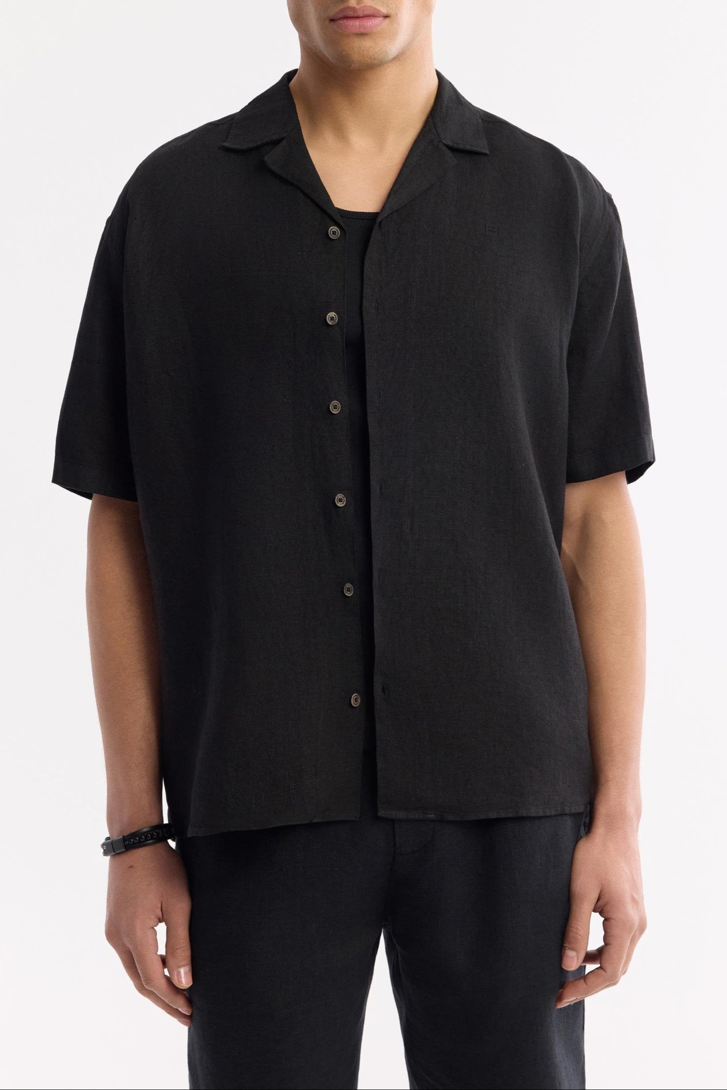 Relaxed fit black linen shirt worn buttoned up