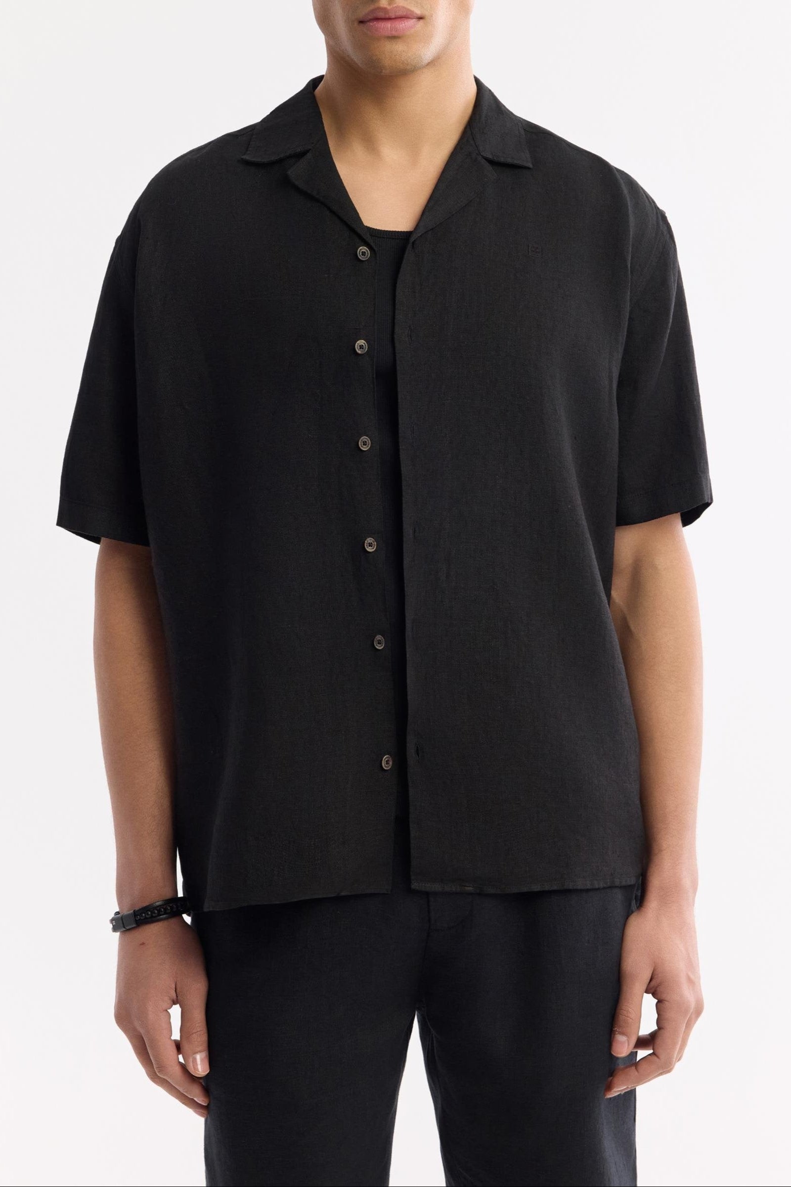 Relaxed fit black linen shirt worn buttoned up