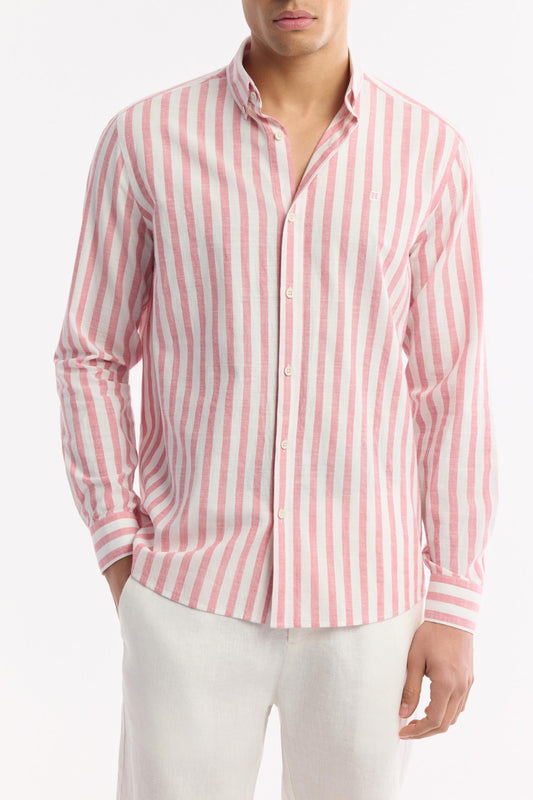 Natural stance in pink striped shirt and white linen