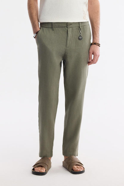 Model wearing Olive Green Linen Pants with white shirt and sandals