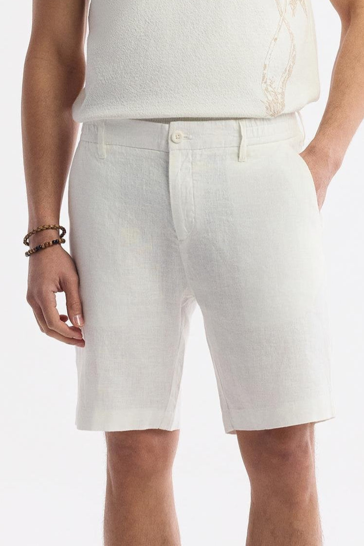 Model front-facing wearing white linen shorts, summer styling