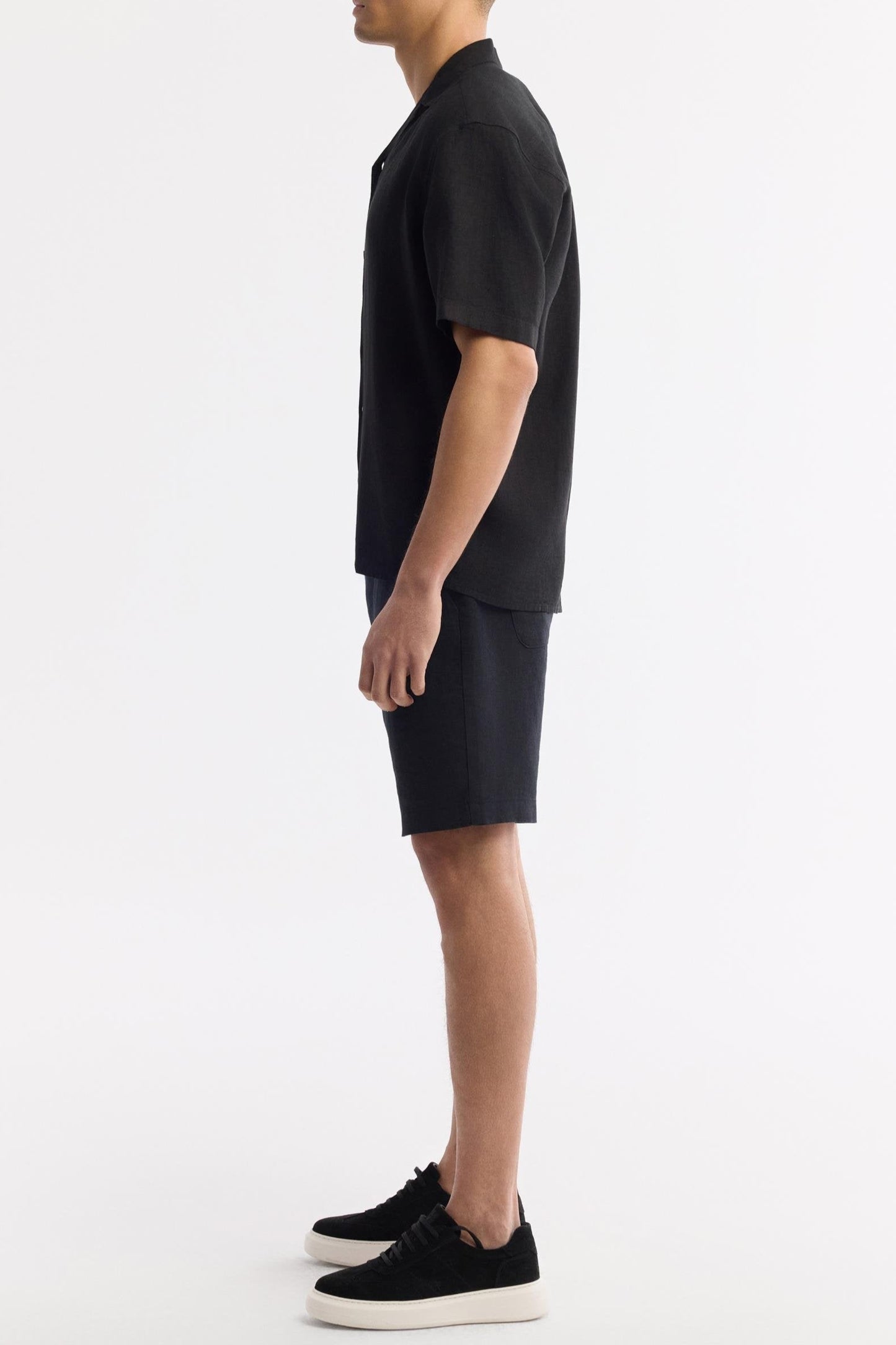 Side profile of men's black short sleeve linen shirt