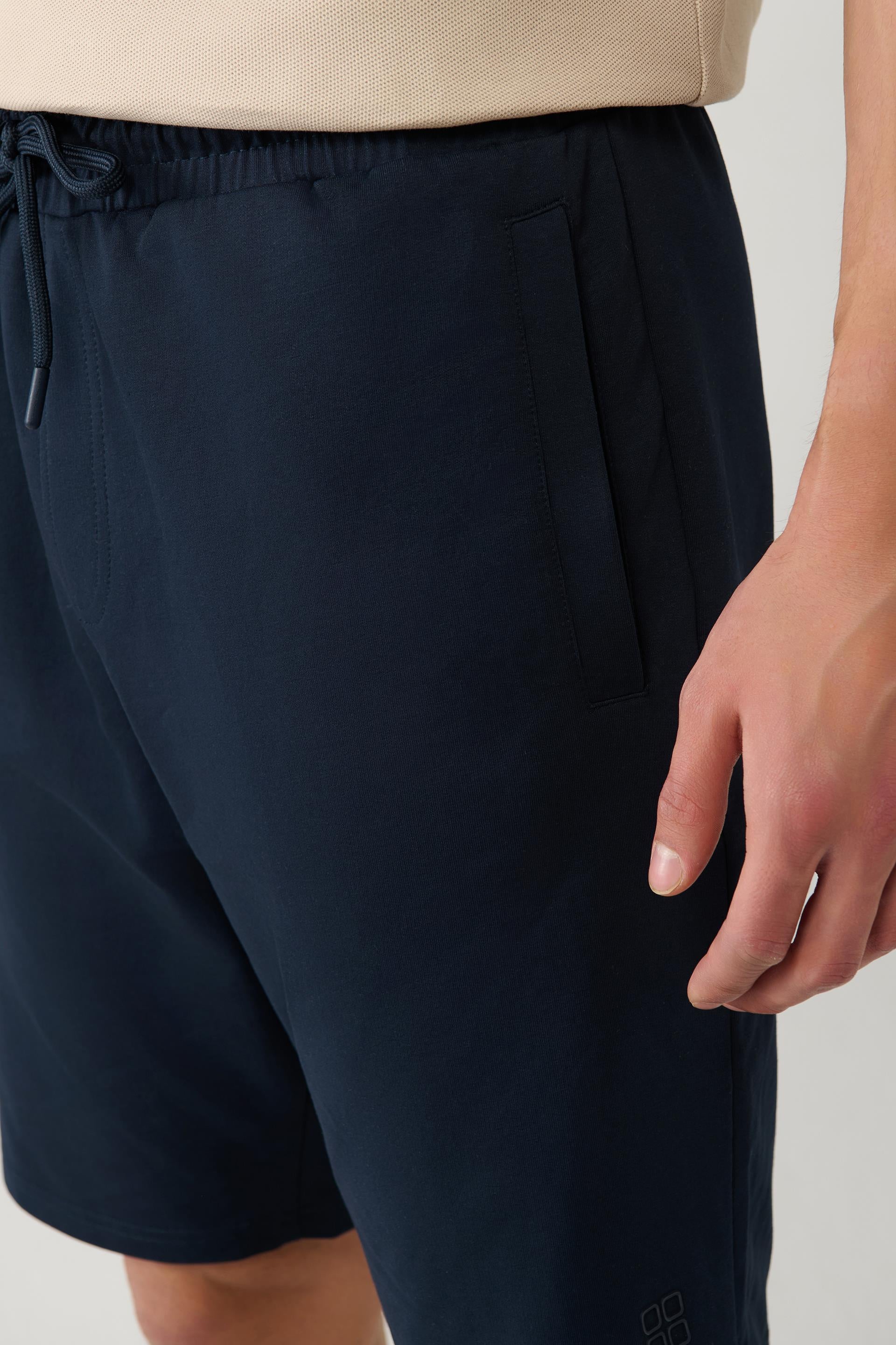 Close-up of side pocket and waistband on navy cotton shorts – Swiftyle