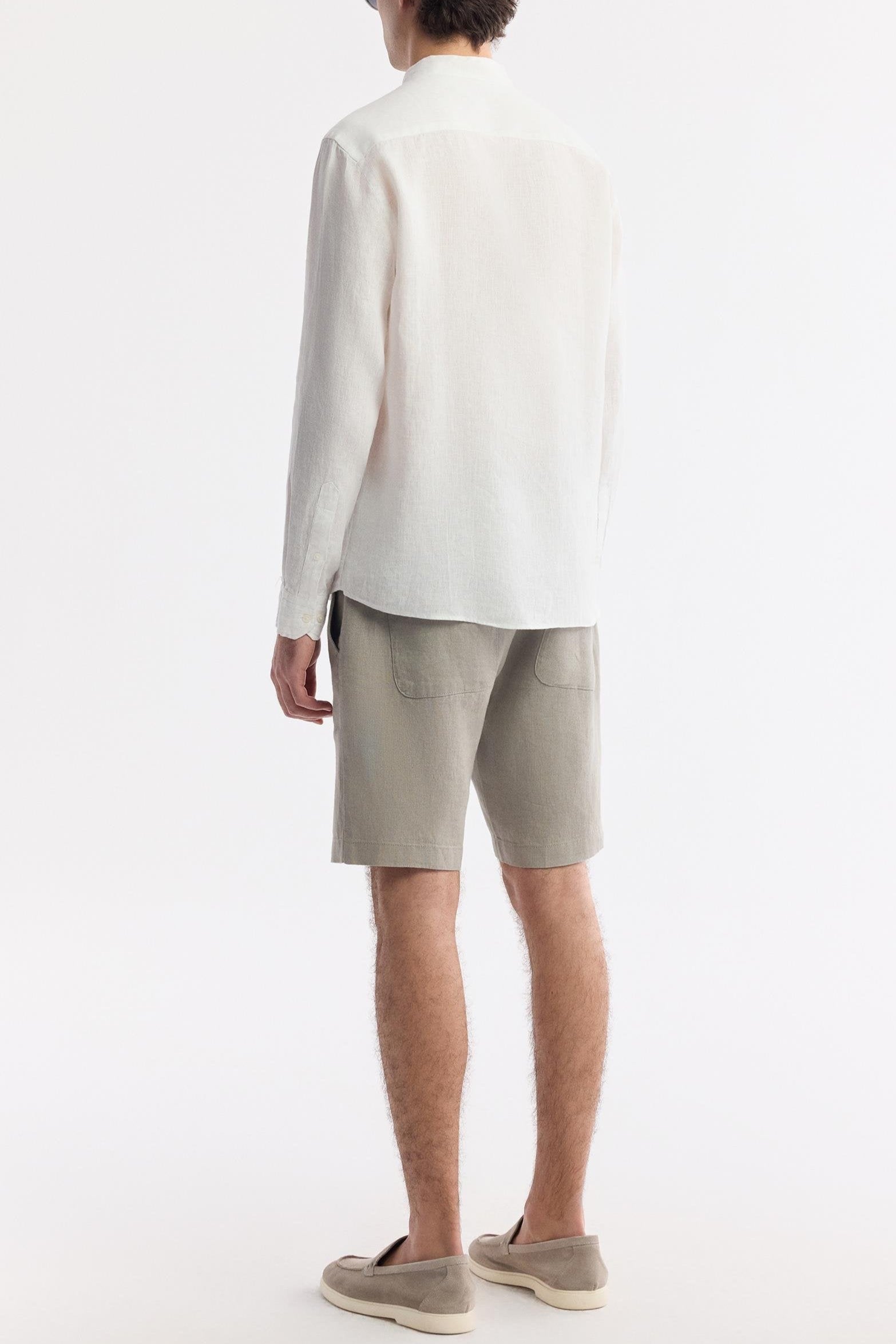 Back view of men’s white linen grandad shirt showing clean minimal cut