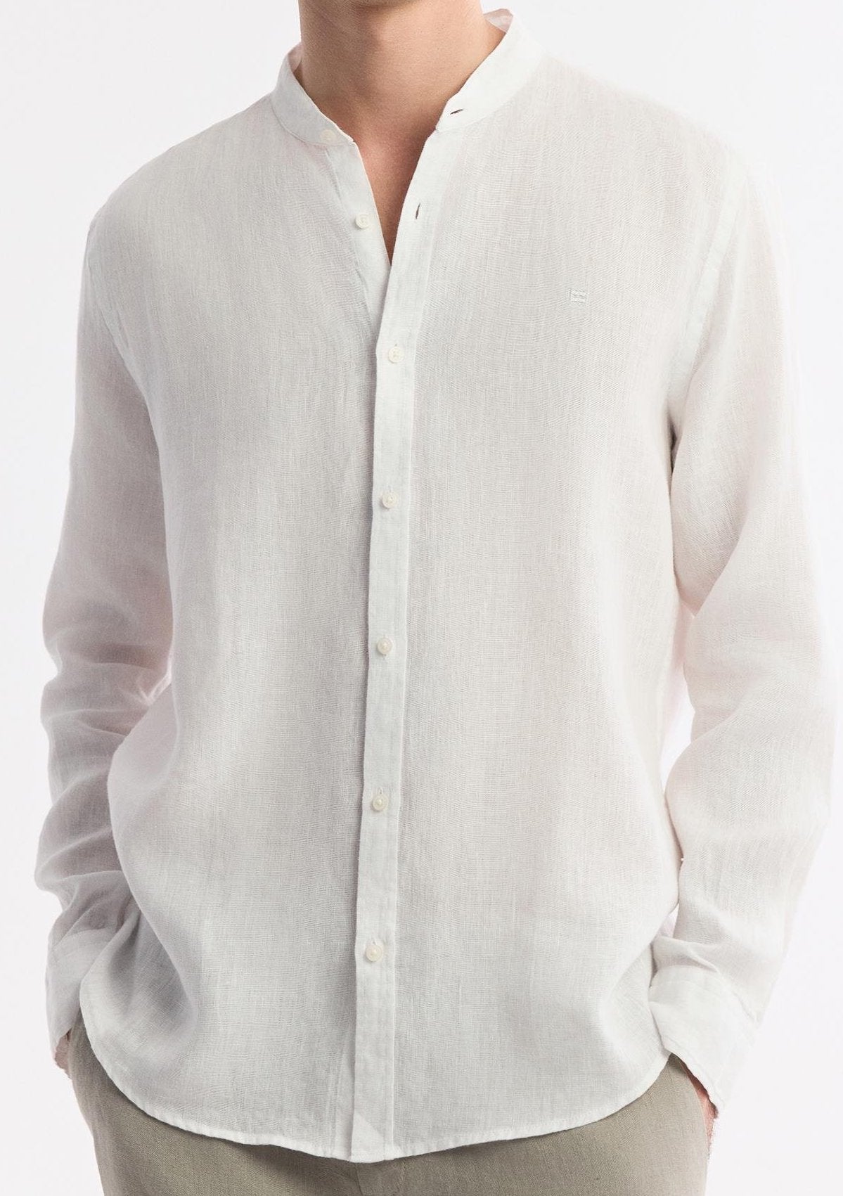 Close-up of collar, buttons, and fabric texture of white linen shirt