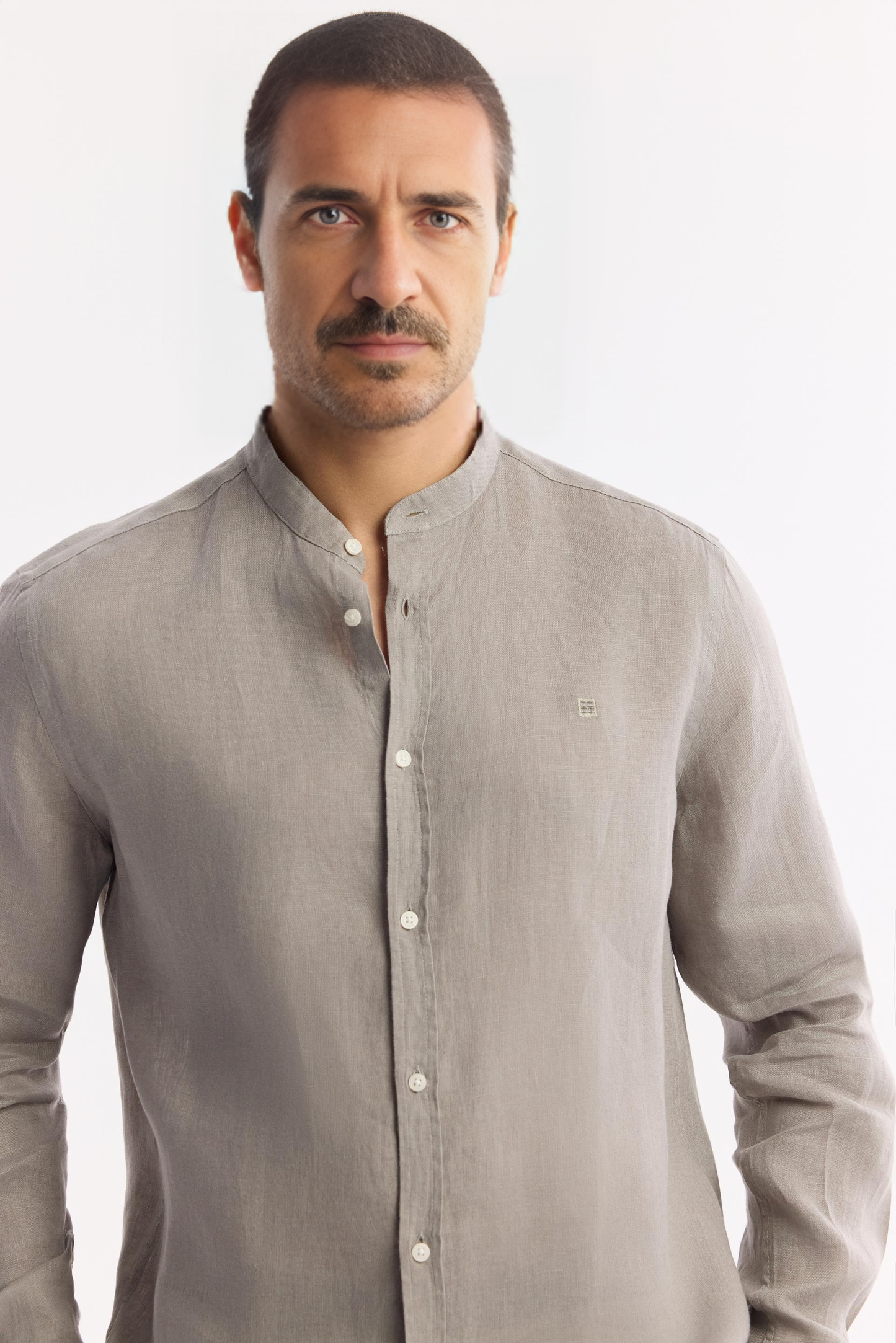 Close-up of buttons and fabric texture on gray linen shirt