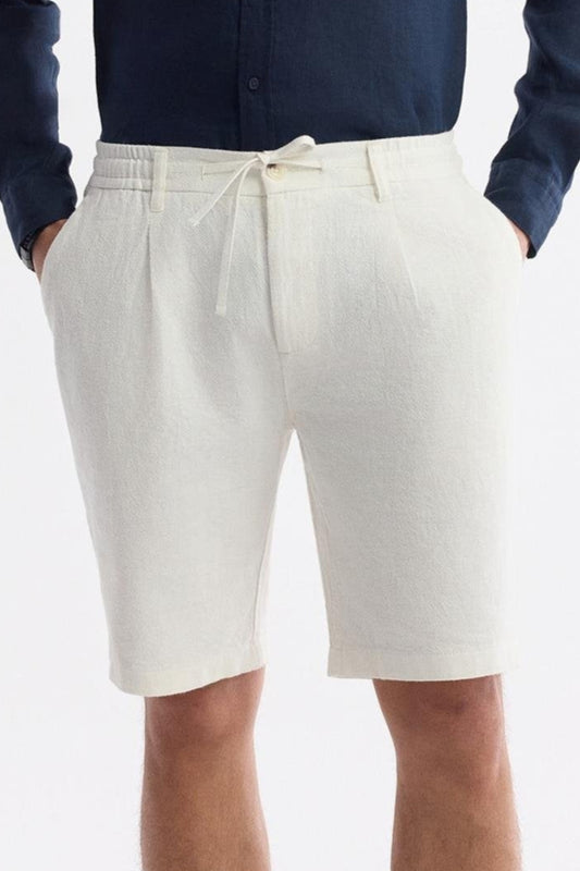 Close-up of drawstring waist and pleats on white linen shorts – Swiftyle