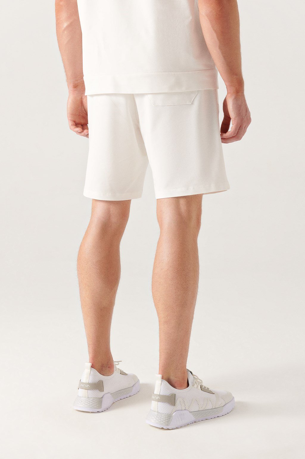 Back full view of white knitted cotton shorts styled with white sneakers – Swiftyle