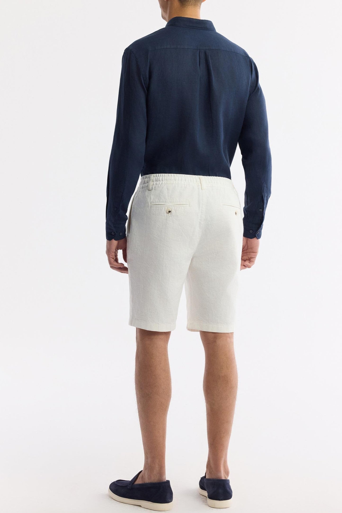 White linen relaxed shorts, rear view showing back welt pockets