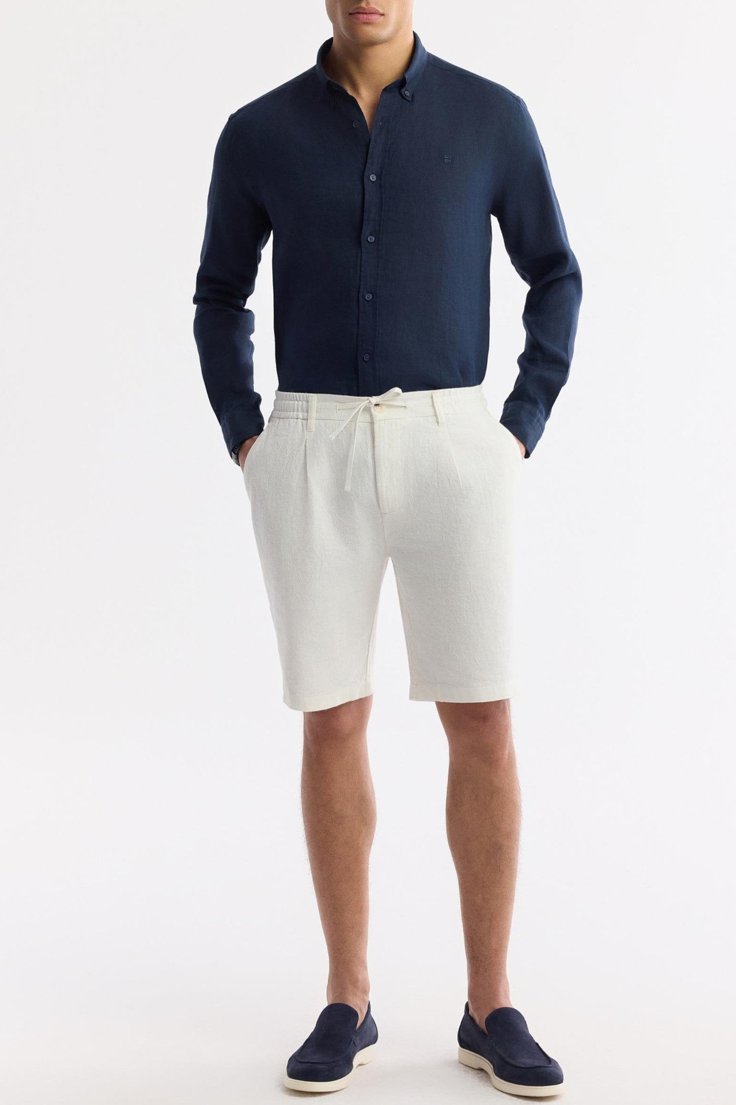 White shorts styled with navy linen shirt, hands in pocket – Swiftyle