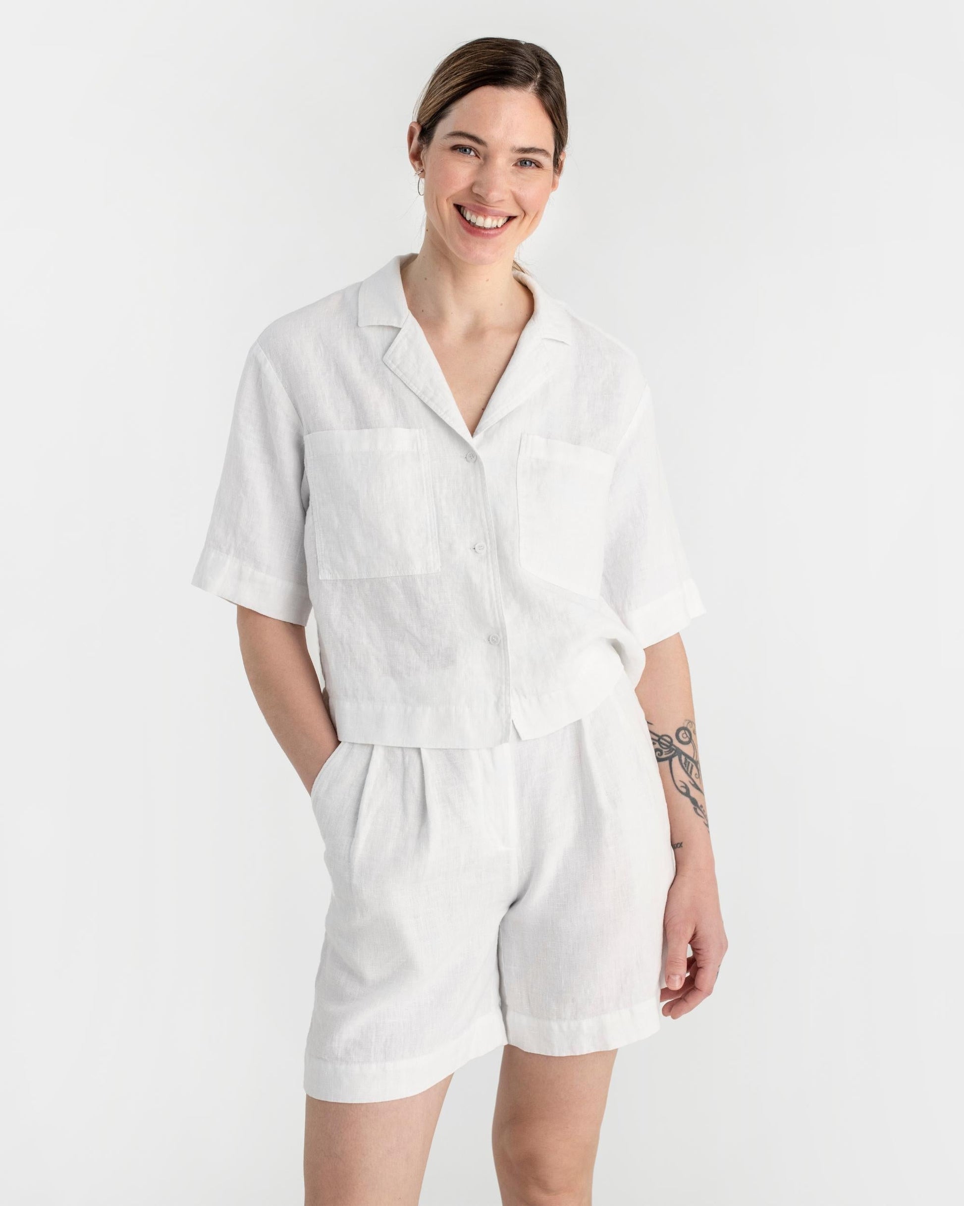 Woman wearing a white outfit on a plain background